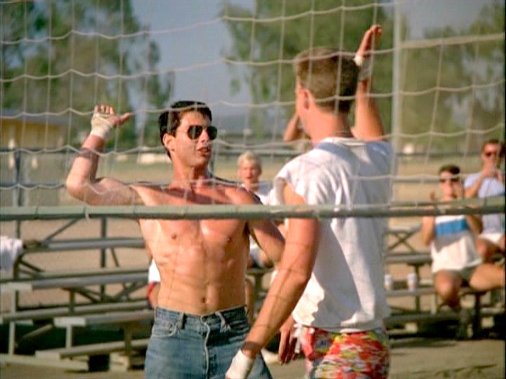 image still from movie Top Gun with Maverick and Goose giving a high five after a good play in a volleyball game