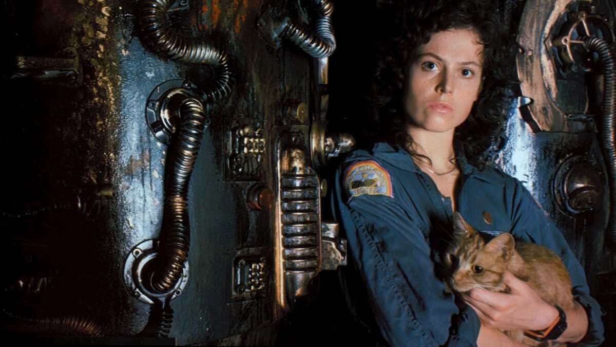 Ripley from Alien posing with Jones the cat on the ship set
