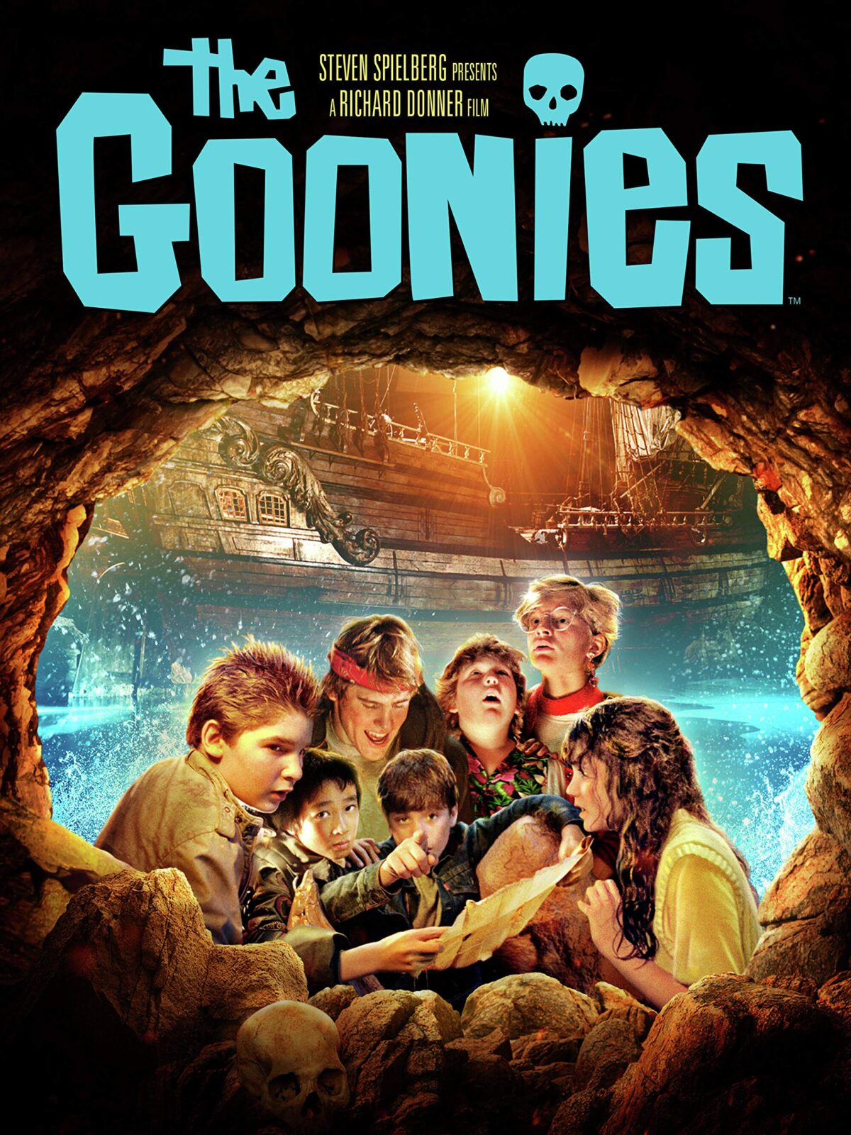 Movie poster for The Goonies featuring all of the Goonies characters looking at a map in a flooded cave in front of a pirate ship