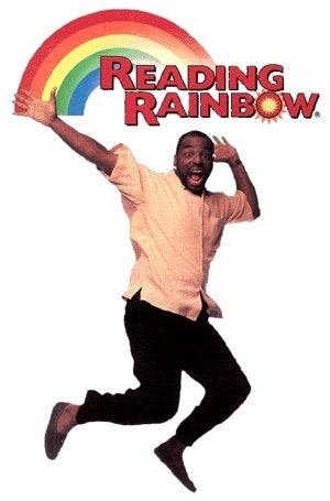 Levar Burton jumps in the air under a rainbow with reading rainbow at the end of the rainbow
